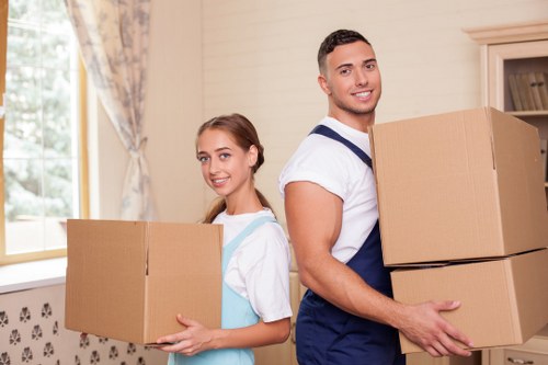Careful moving of furniture through a narrow stairwell in a local Holland Park property